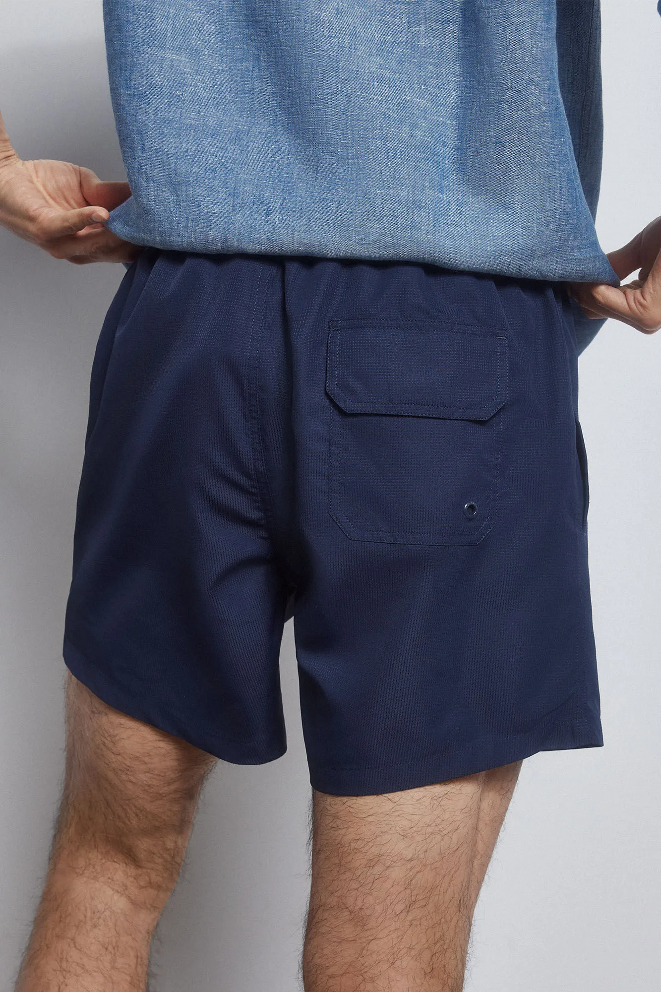 Textured fabric button fastening swim shorts